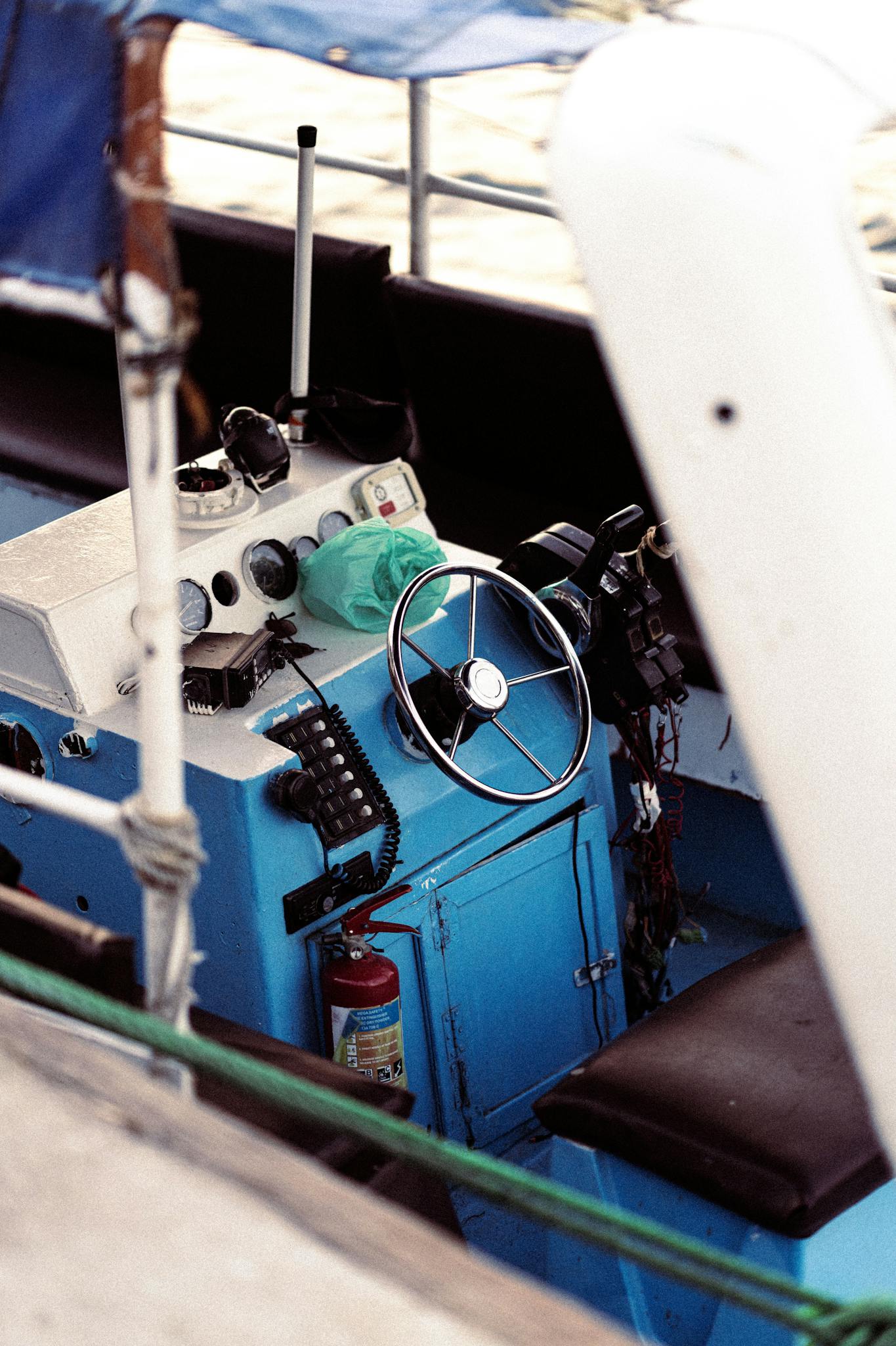 Close-up of a boat's control panel and steering wheel in Dubai, UAE.