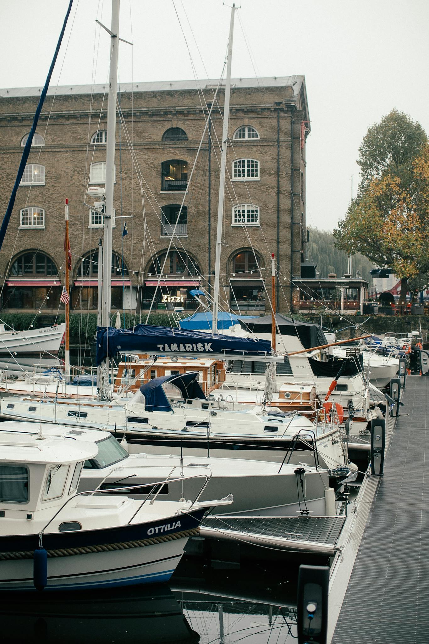 Luxurious yachts docked at a marina in historic London, perfect for travel and leisure activities.